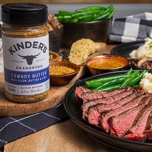 Sliced grilled ribeye steak drizzled with cowboy butter sauce