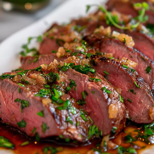 Grilled picanha steak with a crispy seared edge and fresh herbs
