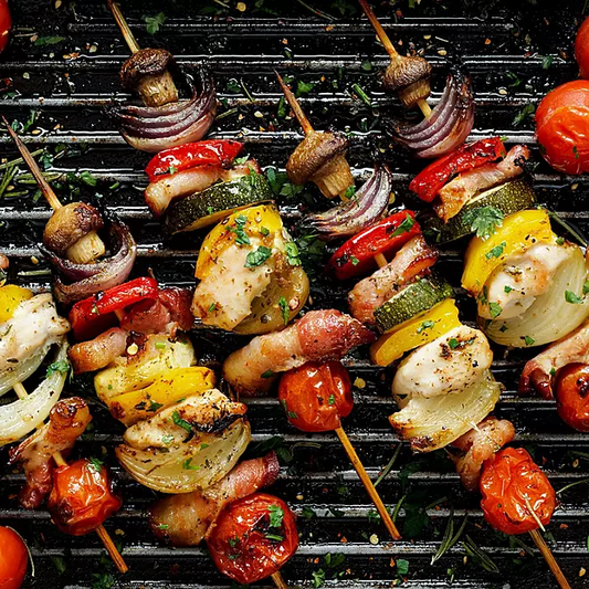 Char-grilled veggie skewers with peppers, onions, and zucchini on a wooden board