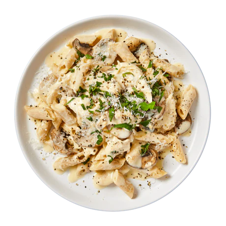 Bowl of pasta tossed with roasted veggies, herbs, and garlic butter